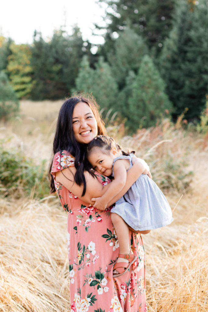 Portland OR mommy and me session in a local park featuring mother and daughter snuggled together